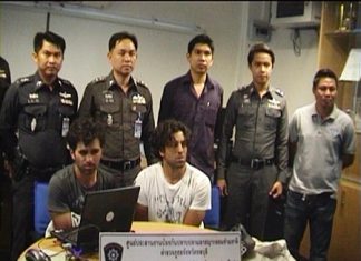 French nationals Alexandre Giro Zinno and Ali Ennouri (seated) are held for questioning at Pattaya Police Station following their arrest on Feb. 15.